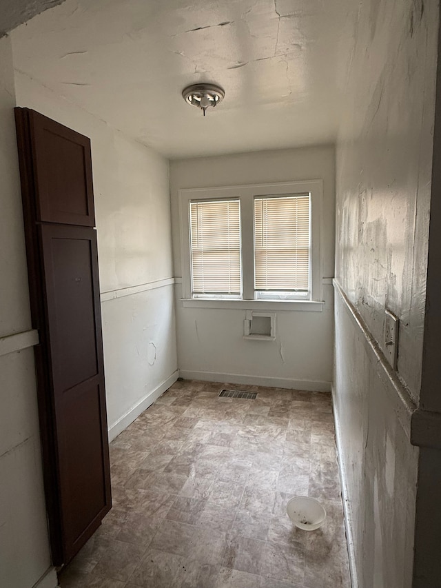 unfurnished room featuring visible vents, baseboards, and tile patterned floors