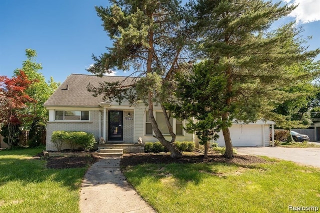 view of front facade with brick siding, a shingled roof, concrete driveway, a garage, and a front lawn