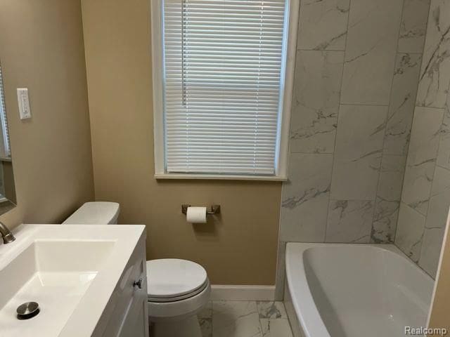 full bath with toilet, marble finish floor, baseboards, and vanity