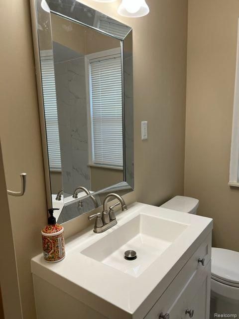 bathroom featuring toilet and vanity