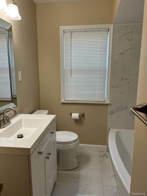 full bathroom with toilet, vanity, baseboards, marble finish floor, and a bathtub