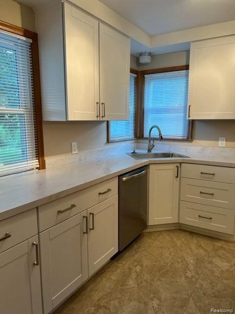 kitchen featuring a sink, light countertops, and stainless steel dishwasher