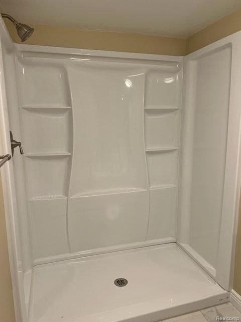 full bath with a shower stall