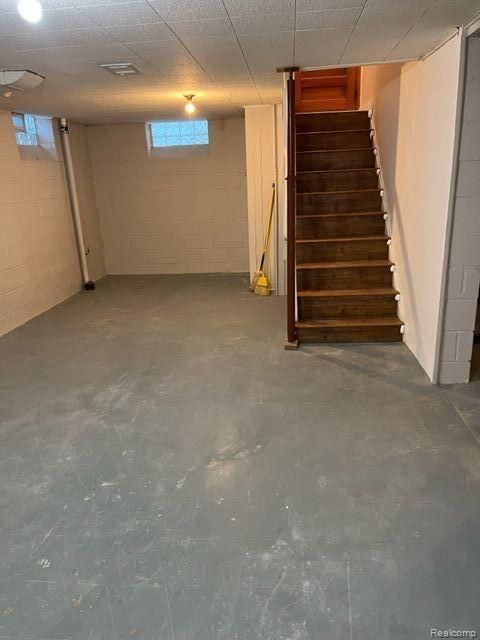 below grade area with concrete block wall and stairway