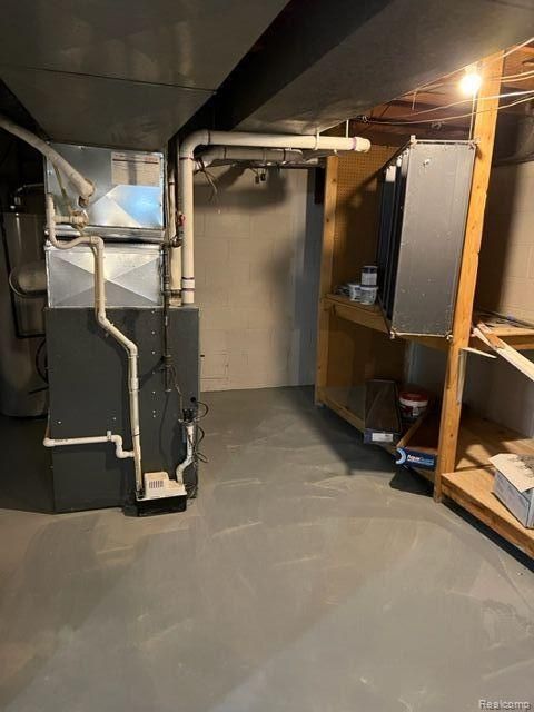 unfinished basement featuring heating unit