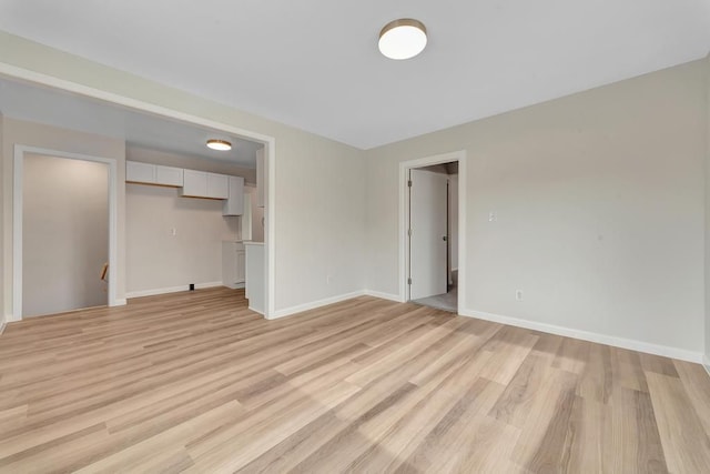 interior space featuring light wood-style flooring and baseboards