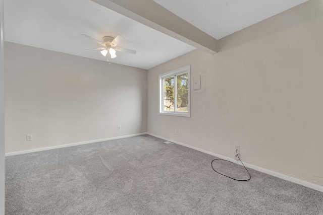 carpeted empty room featuring a ceiling fan, beam ceiling, and baseboards