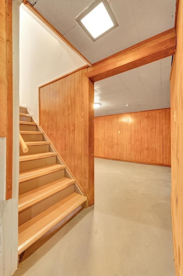 finished basement featuring stairs, wooden walls, and a sauna