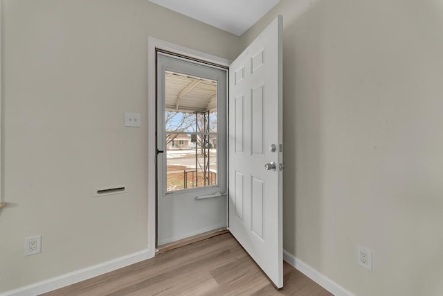 entryway featuring light wood-style flooring and baseboards