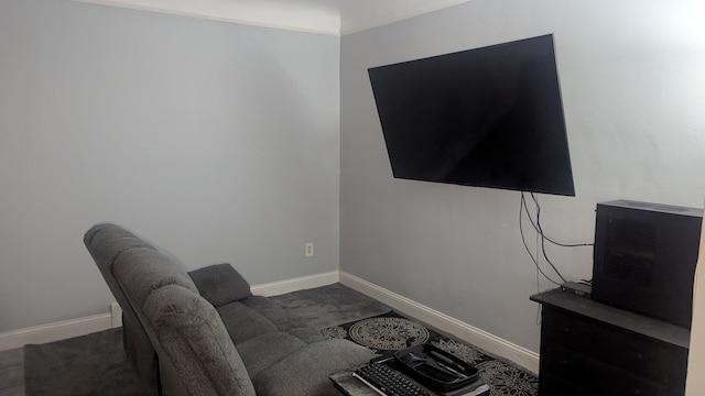 living area featuring baseboards