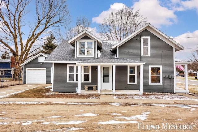 view of front of property with covered porch, concrete driveway, a shingled roof, and a garage