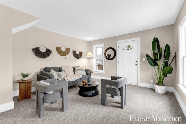 living room featuring carpet flooring and baseboards