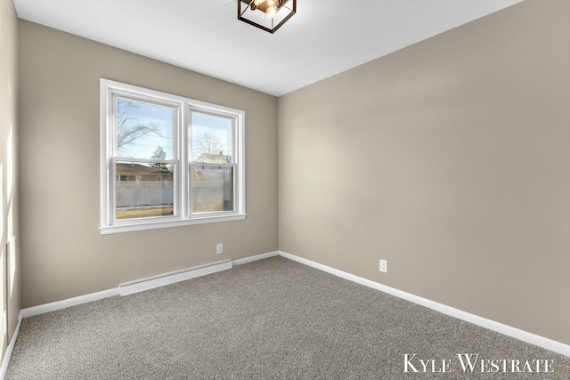 spare room with carpet floors, baseboards, and baseboard heating