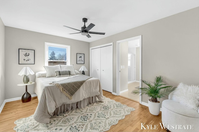 bedroom featuring light wood-type flooring, a closet, ceiling fan, and baseboards