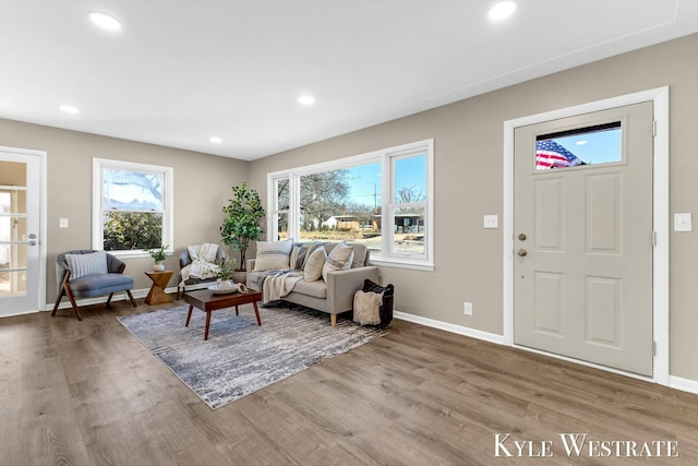 living room featuring baseboards, wood finished floors, and recessed lighting