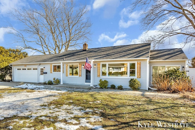 view of front of property with a garage, driveway, and a chimney