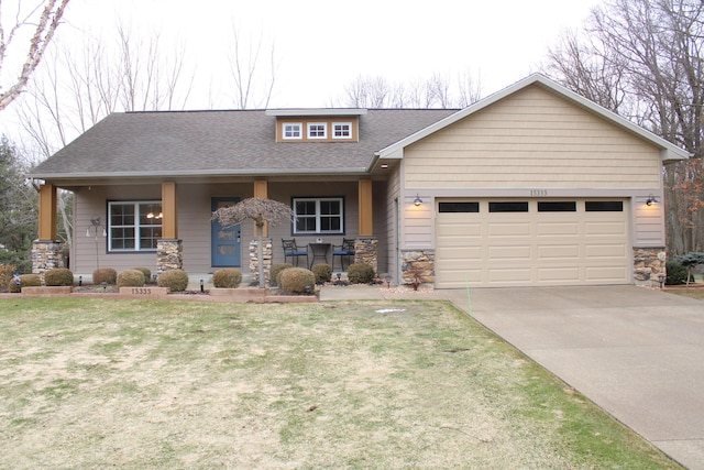 view of front of property featuring driveway, stone siding, roof with shingles, an attached garage, and covered porch