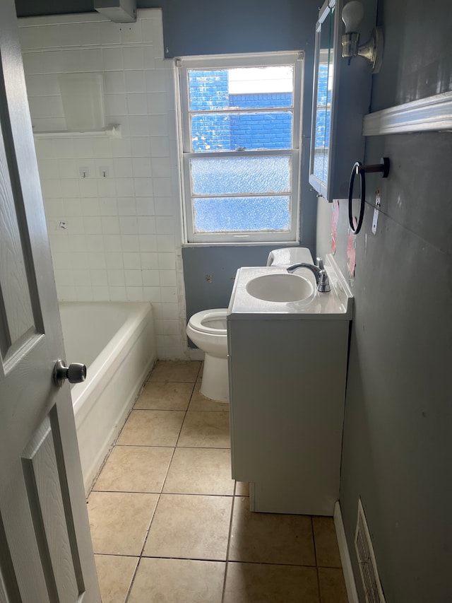 bathroom featuring toilet, vanity, visible vents, and tile patterned floors