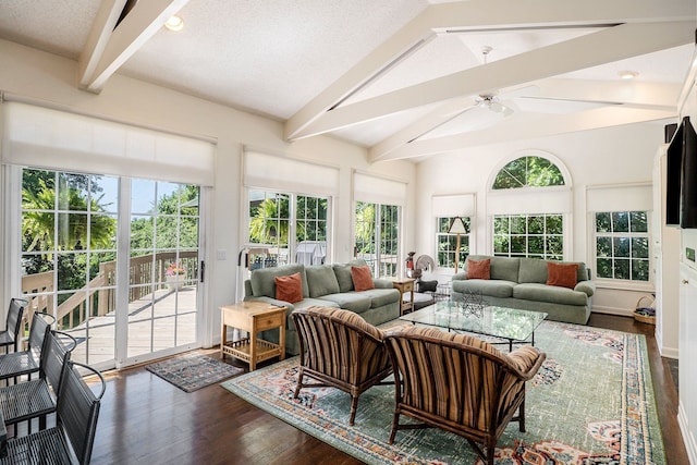 sunroom featuring a ceiling fan and lofted ceiling with beams