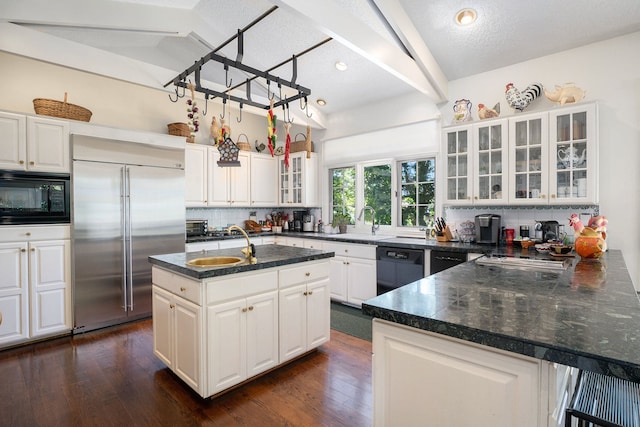 kitchen featuring dark wood-style flooring, tasteful backsplash, dark countertops, lofted ceiling with beams, and black appliances