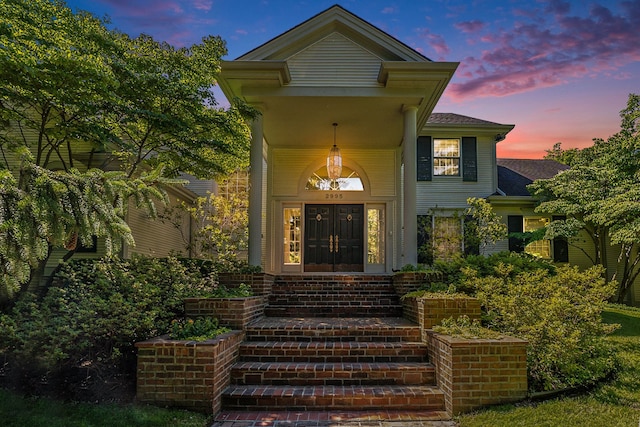 view of exterior entry at dusk