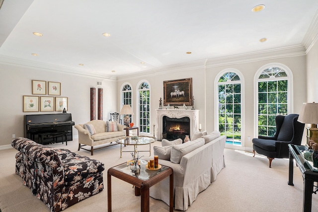 living room featuring a warm lit fireplace, recessed lighting, crown molding, and light colored carpet