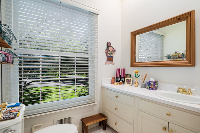 bathroom featuring visible vents, vanity, and toilet