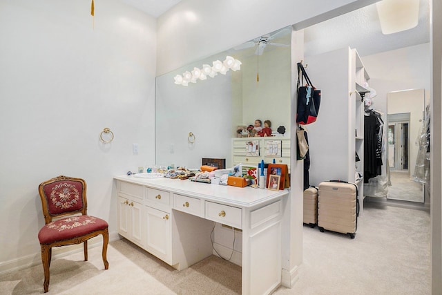 bathroom with baseboards, a ceiling fan, and vanity