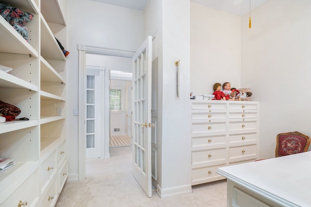 spacious closet featuring visible vents and light colored carpet