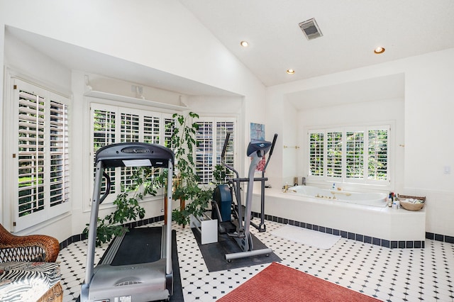 exercise area featuring visible vents, vaulted ceiling, and recessed lighting