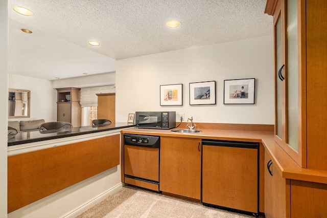 kitchen featuring a sink, a textured ceiling, black microwave, dishwasher, and fridge