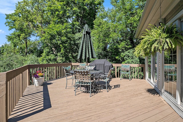 wooden terrace with outdoor dining area