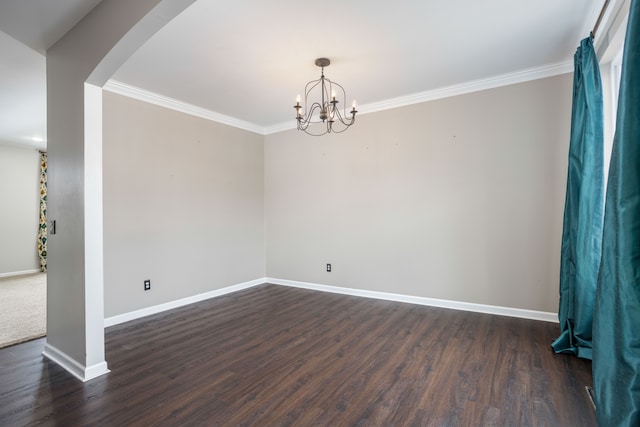 unfurnished room with a notable chandelier, ornamental molding, dark wood-style floors, arched walkways, and baseboards