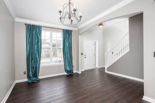 interior space featuring arched walkways, stairway, ornamental molding, and wood finished floors