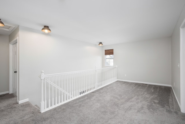 spare room with baseboards and carpet