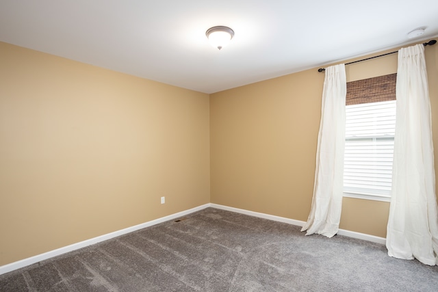 carpeted spare room with baseboards