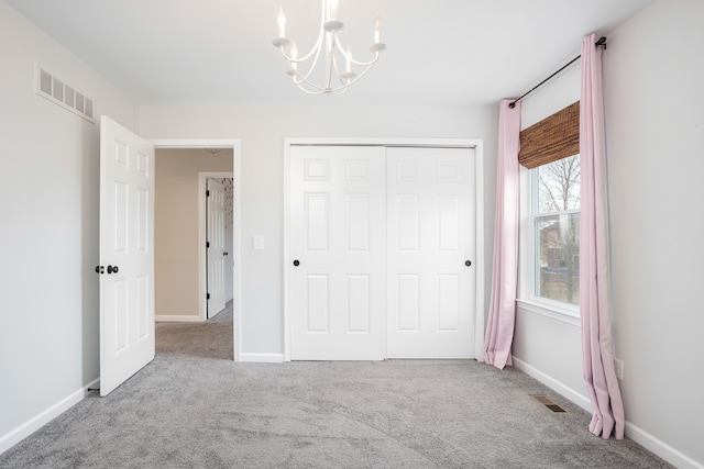 unfurnished bedroom with a closet, visible vents, and carpet floors