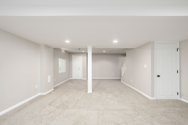 finished below grade area with stairs, recessed lighting, baseboards, and light carpet