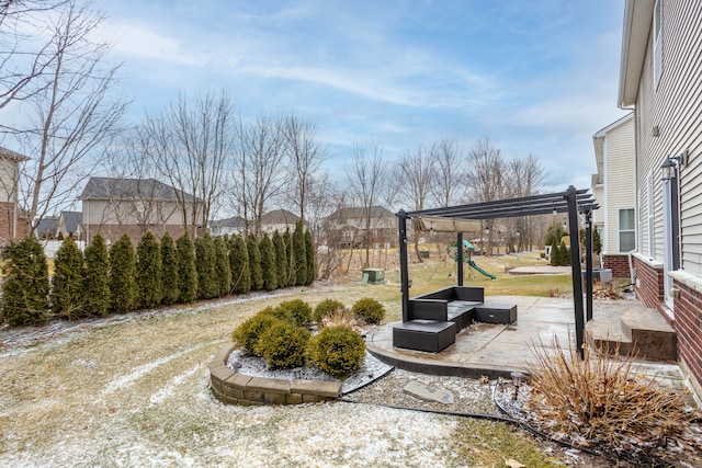 view of yard featuring a patio area, a playground, and a pergola