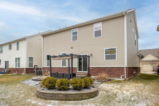 rear view of property featuring cooling unit, brick siding, an outdoor structure, and a pergola