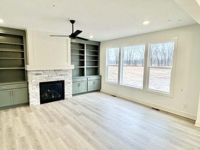 unfurnished living room with recessed lighting, a fireplace, wood finished floors, visible vents, and baseboards