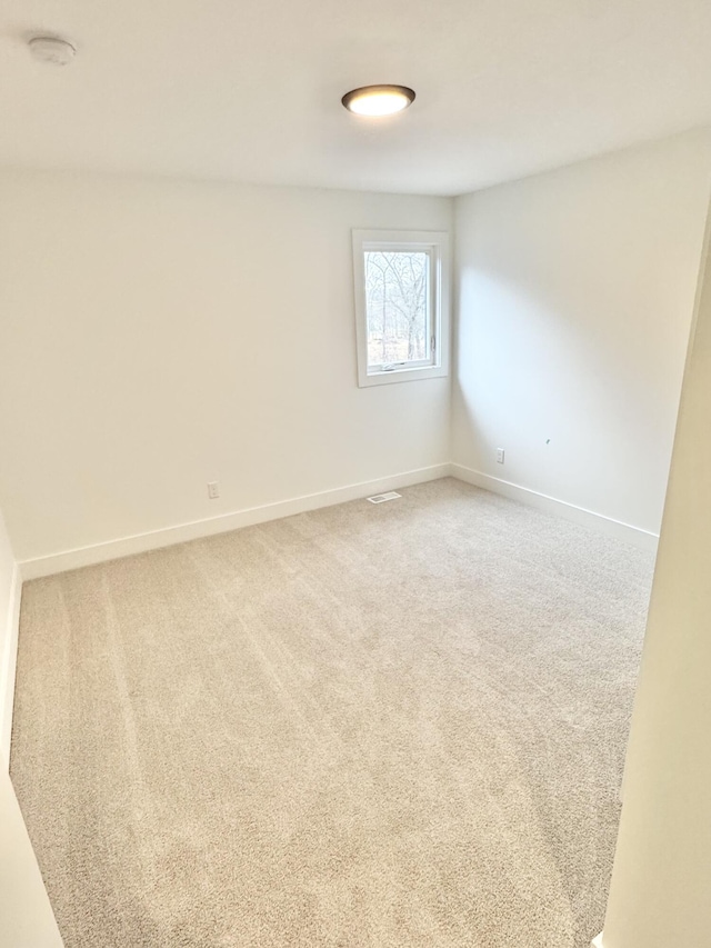 empty room with carpet floors and baseboards