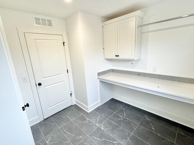 laundry area featuring marble finish floor, visible vents, and baseboards