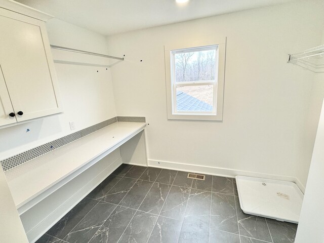 laundry area with marble finish floor, visible vents, and baseboards