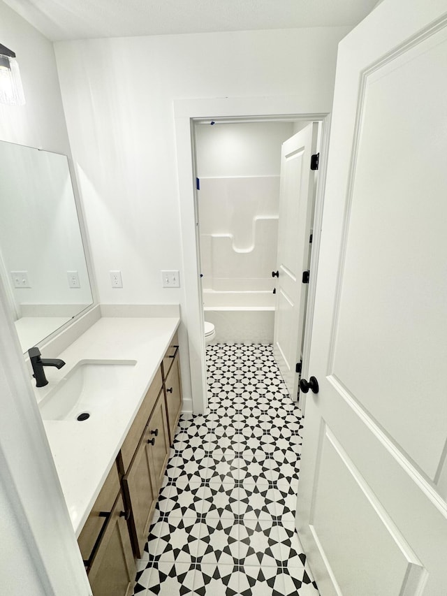 full bathroom featuring vanity, toilet, and tile patterned floors