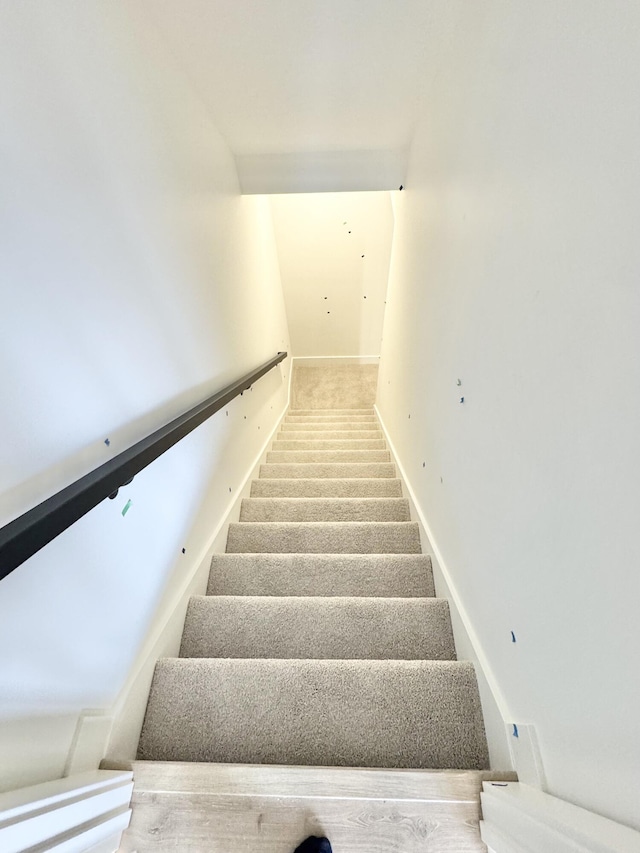 stairs featuring carpet