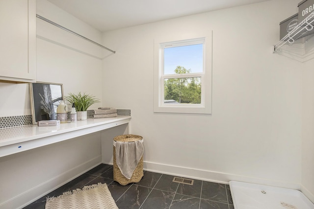 7711 96th St SE, Alto, MI 49302 - laundry room featuring baseboards and dark marble finish flooring