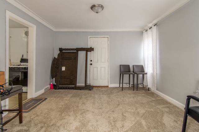 carpeted entrance foyer with crown molding and baseboards