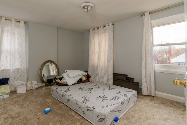 carpeted bedroom featuring baseboards