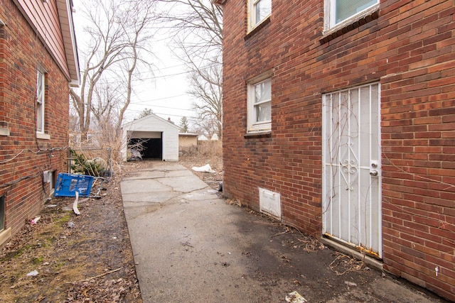 view of side of home featuring an outbuilding and brick siding